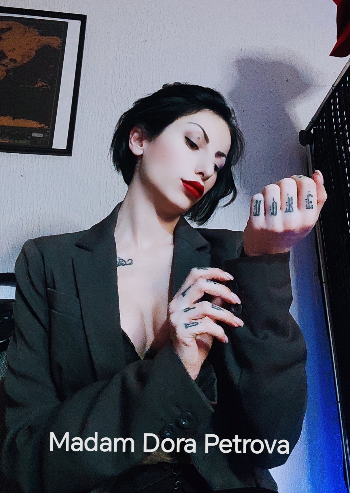 Dominant and strict lady with red lipstik on her mouth and black hair wearing bussines suit